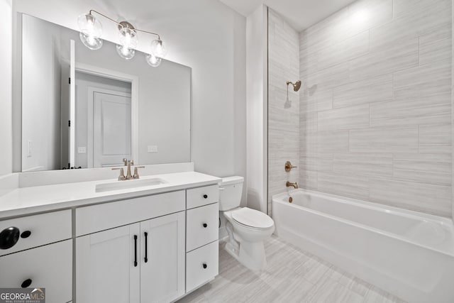 bathroom featuring toilet, shower / bathing tub combination, and vanity