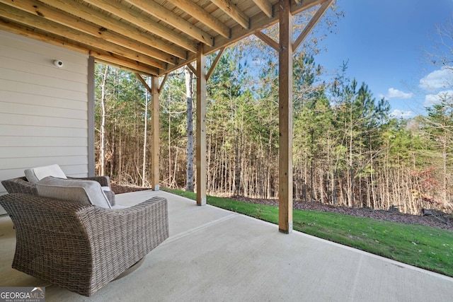 view of patio / terrace featuring a view of trees