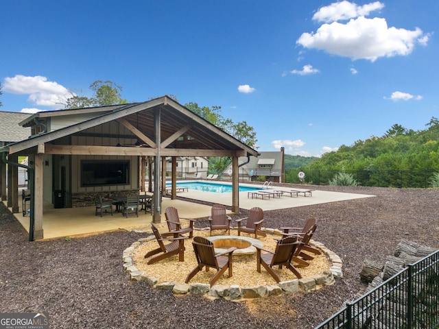 exterior space with a fenced in pool, a fire pit, and fence