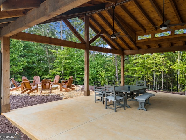 view of patio / terrace with outdoor dining space, fence, a gazebo, a fire pit, and ceiling fan