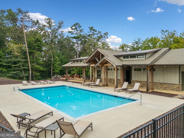 pool featuring a patio area and fence