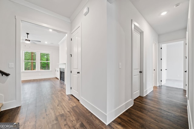 living room featuring a ceiling fan, a fireplace, baseboards, dark wood-style floors, and recessed lighting