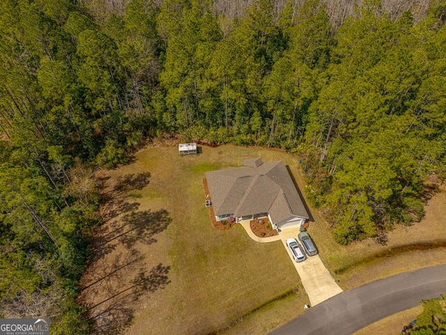 birds eye view of property with a forest view