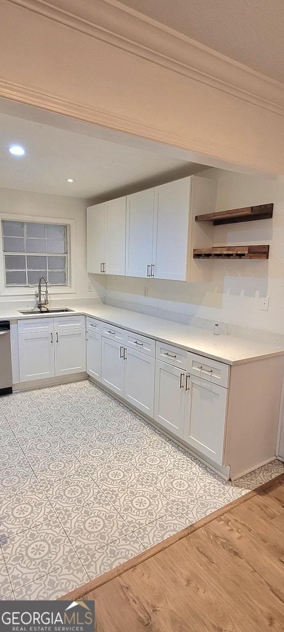 507 Augusta Dr SE, Marietta, GA 30067 - kitchen featuring white cabinetry, sink, and light hardwood / wood-style flooring