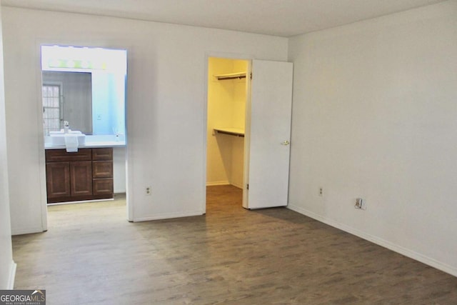 507 Augusta Dr SE, Marietta, GA 30067 - unfurnished bedroom featuring ensuite bath, a spacious closet, hardwood / wood-style floors, and a closet