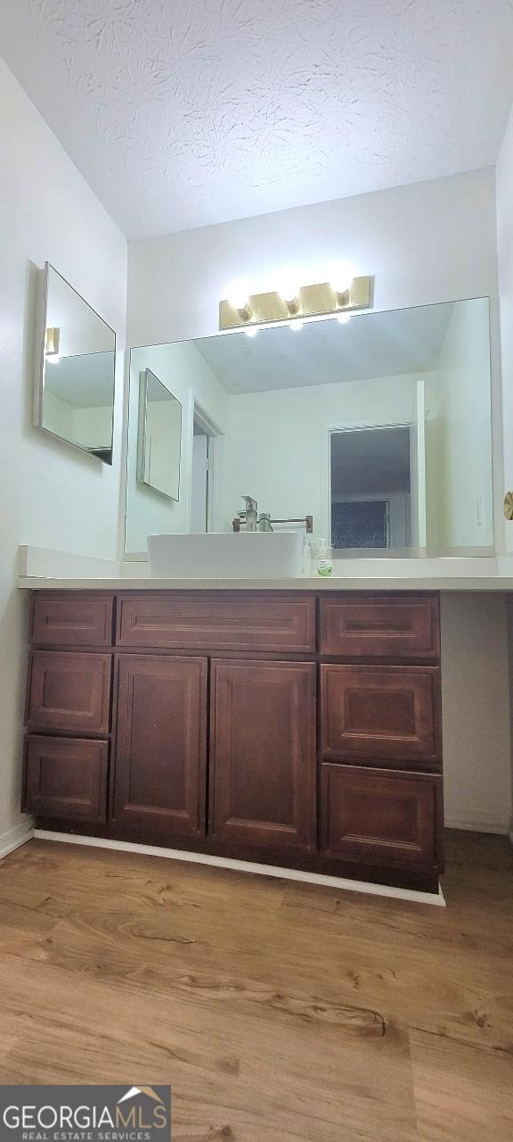 507 Augusta Dr SE, Marietta, GA 30067 - bathroom featuring sink, hardwood / wood-style floors, and a textured ceiling