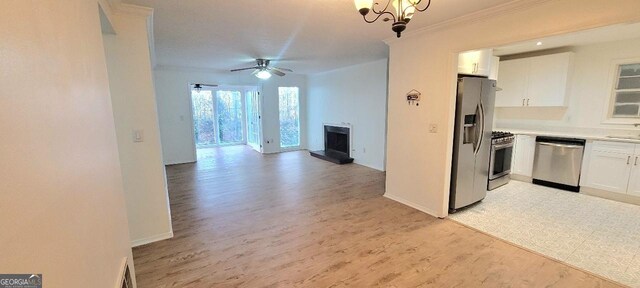 507 Augusta Dr SE, Marietta, GA 30067 - kitchen with stainless steel appliances, white cabinetry, crown molding, and light wood-type flooring