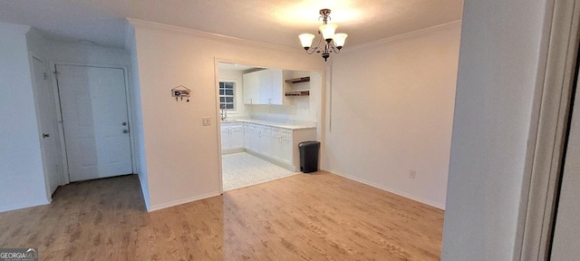 507 Augusta Dr SE, Marietta, GA 30067 - corridor with ornamental molding, an inviting chandelier, and light wood-type flooring