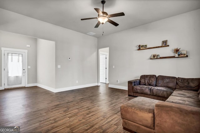 living room featuring ceiling fan and dark hardwood / wood-style flooring