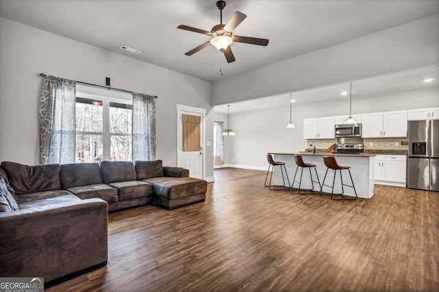 living room featuring hardwood / wood-style floors and ceiling fan