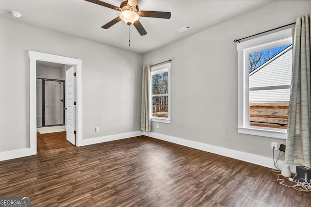 empty room featuring dark hardwood / wood-style flooring and ceiling fan