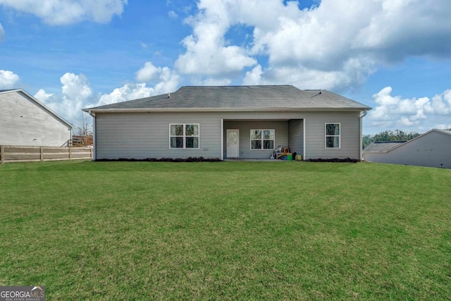 rear view of property with a yard