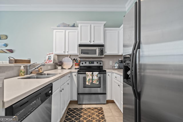 kitchen featuring white cabinetry, stainless steel appliances, sink, and decorative backsplash