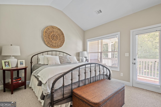 bedroom featuring lofted ceiling, access to exterior, and light colored carpet