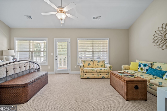 bedroom with ceiling fan, light colored carpet, multiple windows, and access to outside