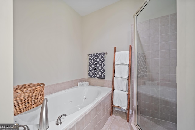 bathroom with tile patterned flooring and separate shower and tub