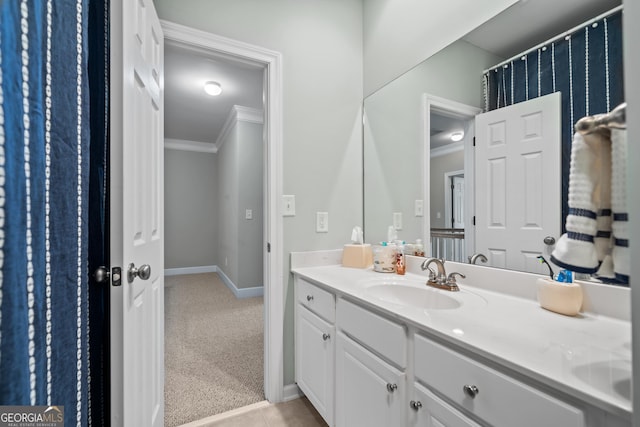 bathroom featuring crown molding, tile patterned floors, and vanity