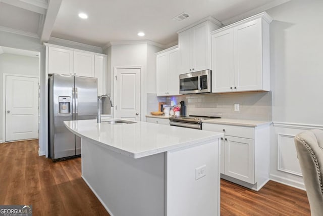 kitchen featuring stainless steel appliances, sink, a center island with sink, and white cabinets