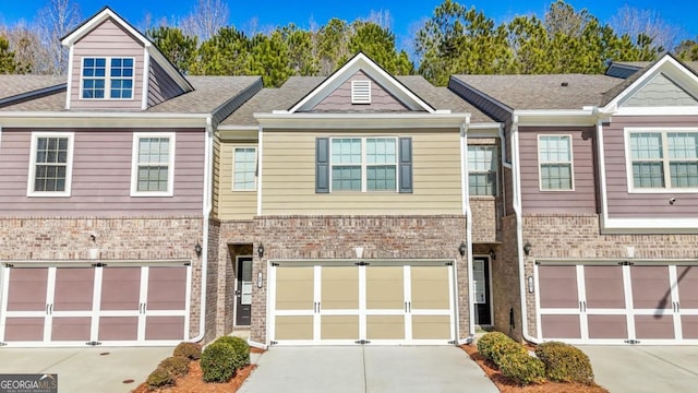 multi unit property featuring driveway and brick siding