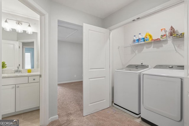 washroom with sink, light colored carpet, and independent washer and dryer