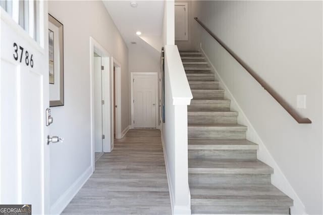 stairs with hardwood / wood-style flooring