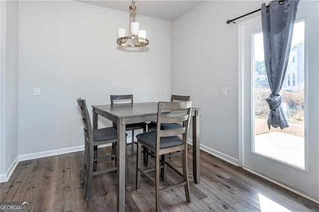 dining space featuring an inviting chandelier and dark hardwood / wood-style floors