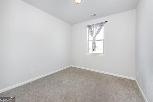 empty room with light colored carpet