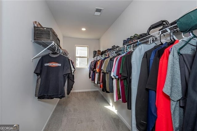 walk in closet featuring carpet