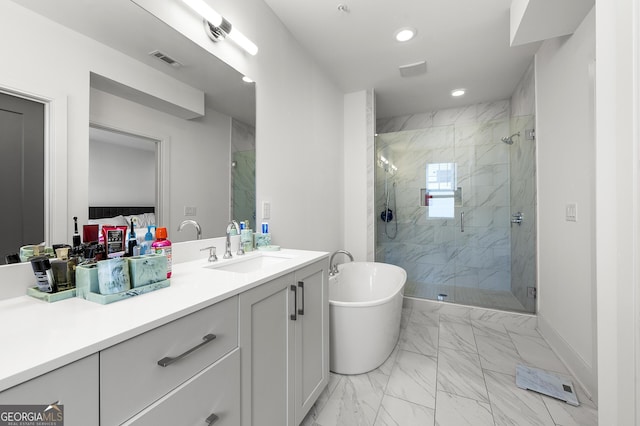 bathroom with vanity and shower with separate bathtub