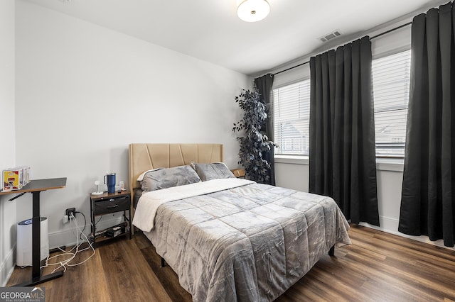 bedroom featuring dark hardwood / wood-style flooring