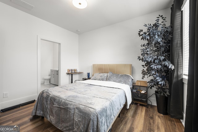 bedroom featuring dark wood-type flooring and ensuite bathroom