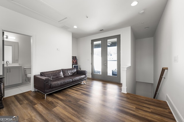 living room featuring dark hardwood / wood-style flooring and french doors