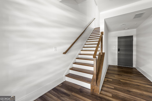 stairway featuring elevator and hardwood / wood-style floors