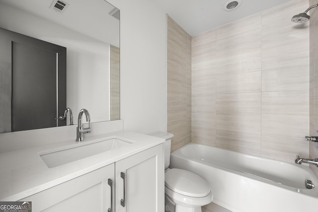 full bathroom featuring vanity, toilet, and tiled shower / bath