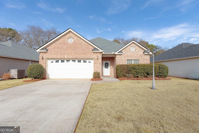 view of front of home featuring a garage and a front lawn