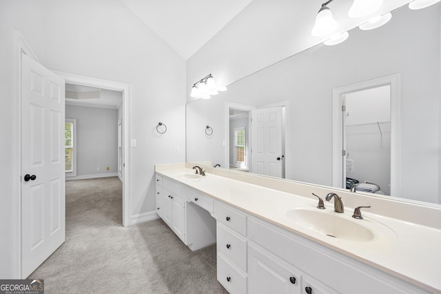 bathroom featuring vanity and lofted ceiling