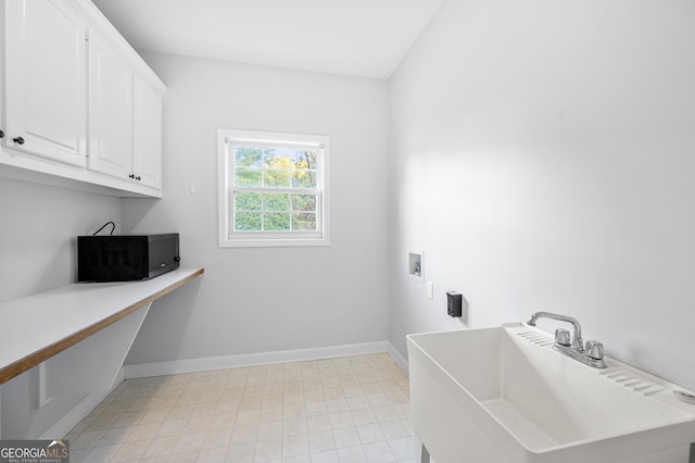 washroom with washer hookup, sink, and cabinets