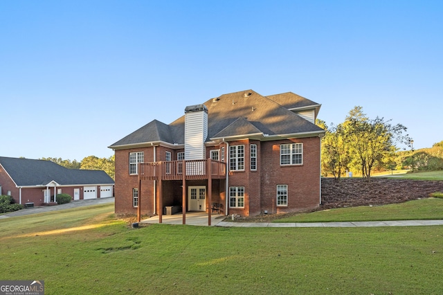 rear view of house featuring a patio area, a lawn, and a deck