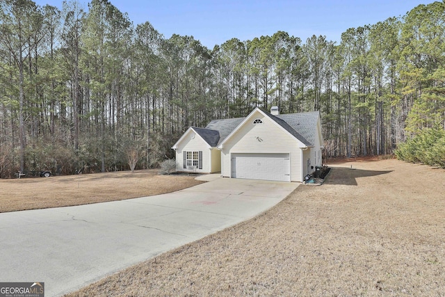 exterior space featuring a garage and a lawn