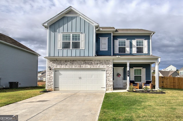 view of front of home with central AC, a porch, a garage, and a front yard