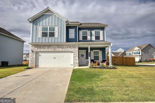 view of front of property with a porch, a garage, central AC unit, and a front yard