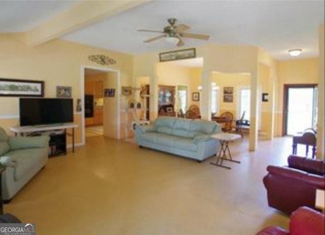 living room featuring ceiling fan and beamed ceiling