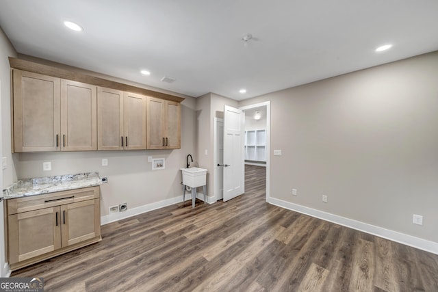 washroom featuring sink, cabinets, dark hardwood / wood-style floors, hookup for a washing machine, and hookup for an electric dryer