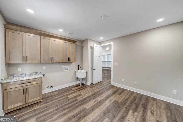 clothes washing area with hookup for a washing machine, dark wood-type flooring, hookup for an electric dryer, and cabinets