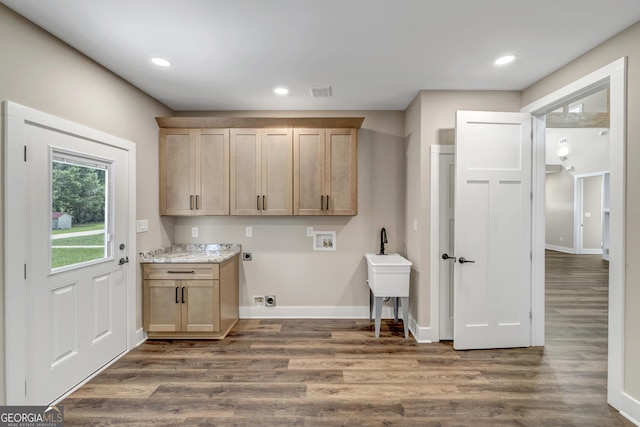 clothes washing area featuring cabinets, washer hookup, dark hardwood / wood-style flooring, and electric dryer hookup