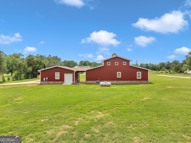 view of home's exterior featuring a garage, an outbuilding, and a lawn