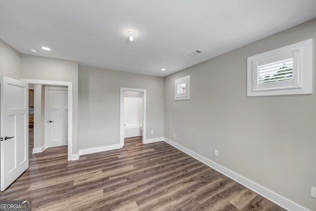 unfurnished bedroom featuring dark wood-type flooring