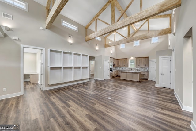 unfurnished living room with dark hardwood / wood-style flooring and lofted ceiling with beams