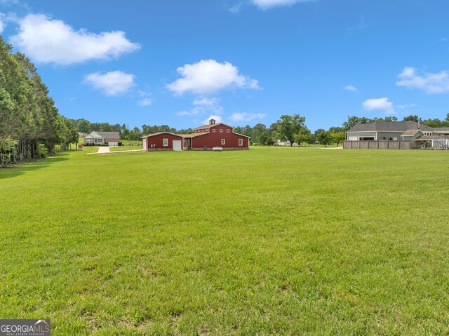 view of yard featuring a rural view and an outdoor structure