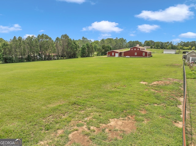 view of yard with a rural view and an outbuilding